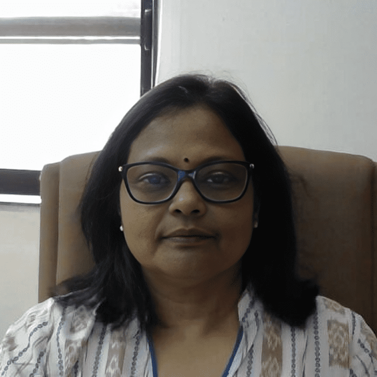 Woman sitting in an office chair, smiling.