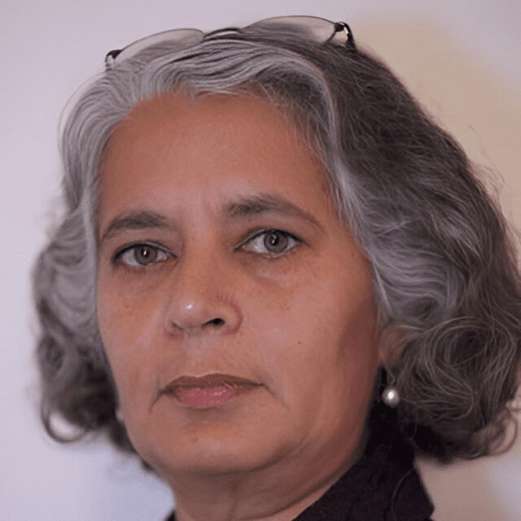 Woman with gray hair and serious expression.