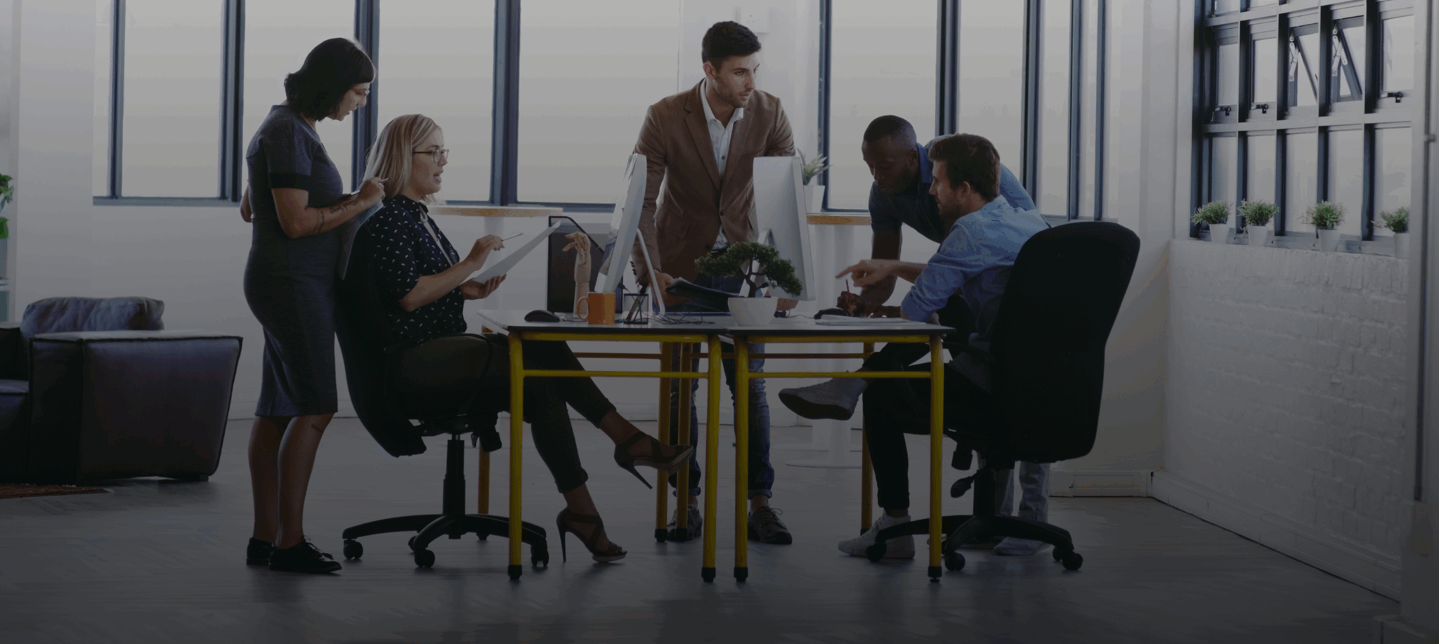 Office team collaborating around a table.