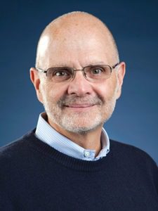 Smiling man with glasses and beard.