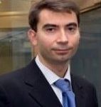 Man in suit with blue tie.