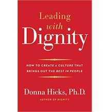 Red book cover: Leading with Dignity title.