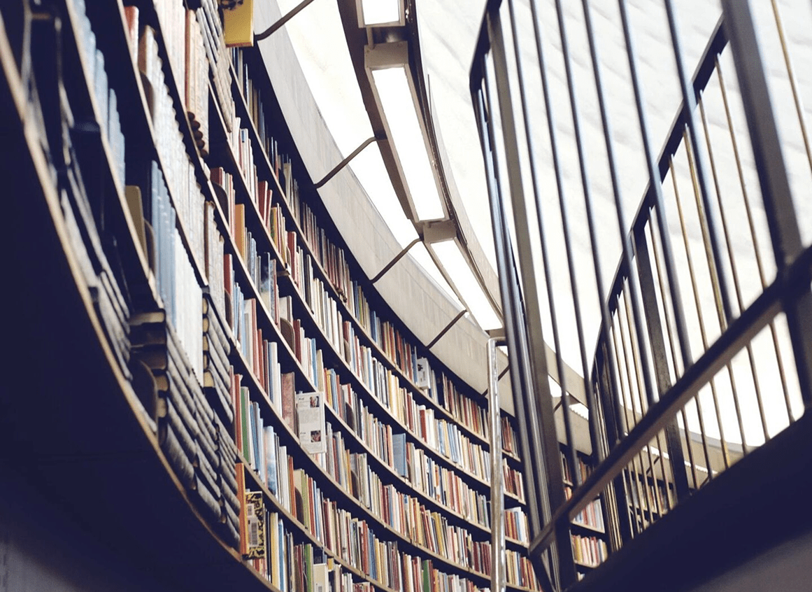 Curved library shelves filled with books.
