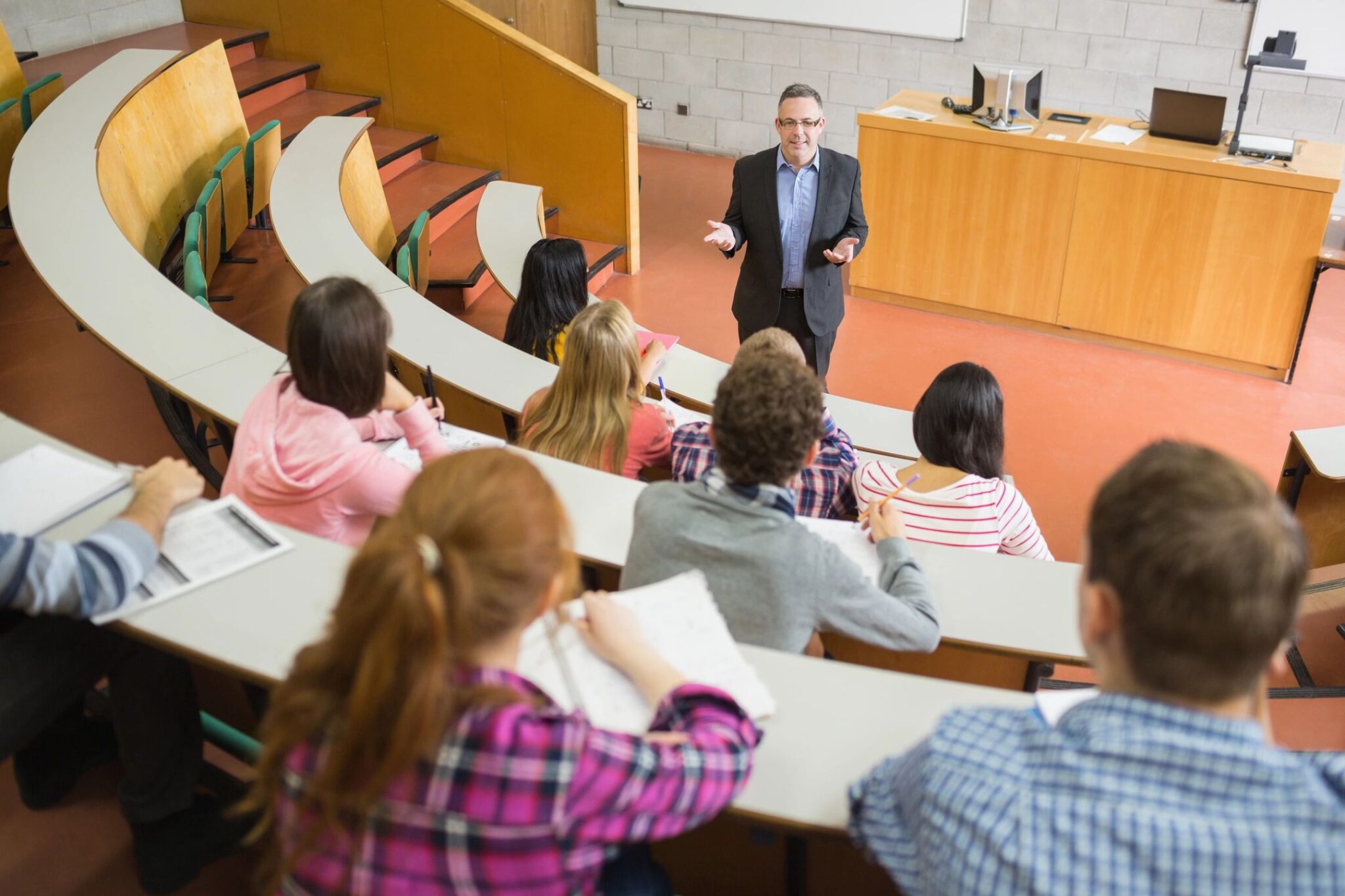 Professor lecturing students in a university classroom.