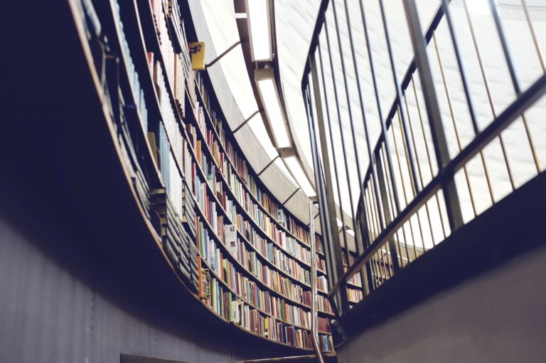 Curved library wall with bookshelves.