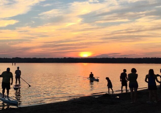 People enjoying sunset by the lake.