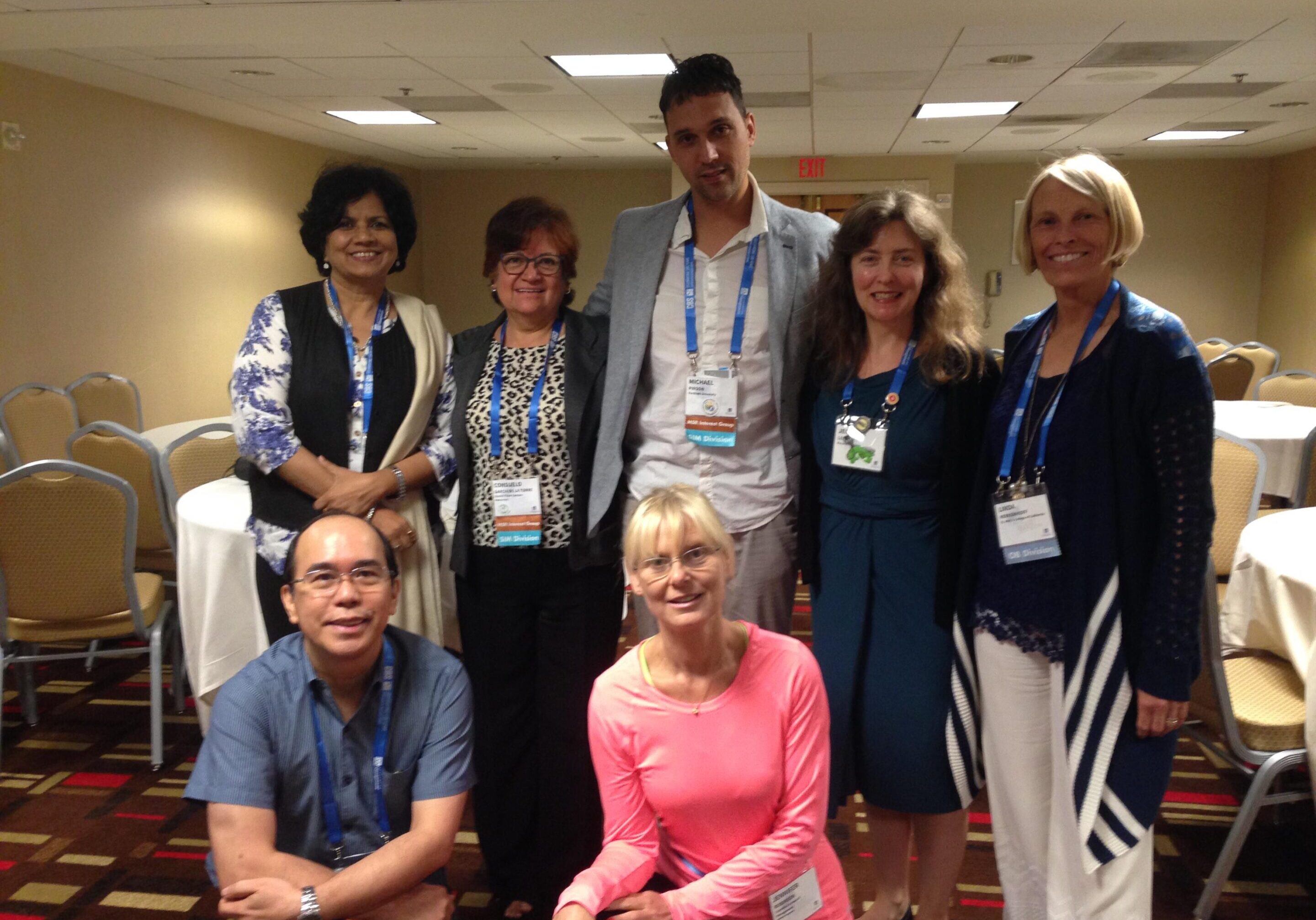 Group of people posing at a conference.