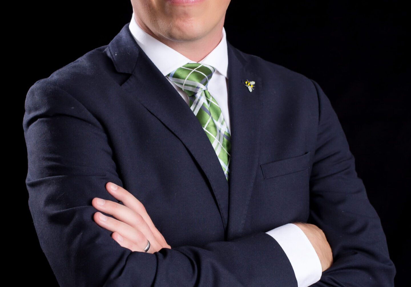 Man in suit with crossed arms.