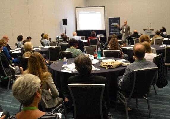 Conference attendees listening to a presentation.
