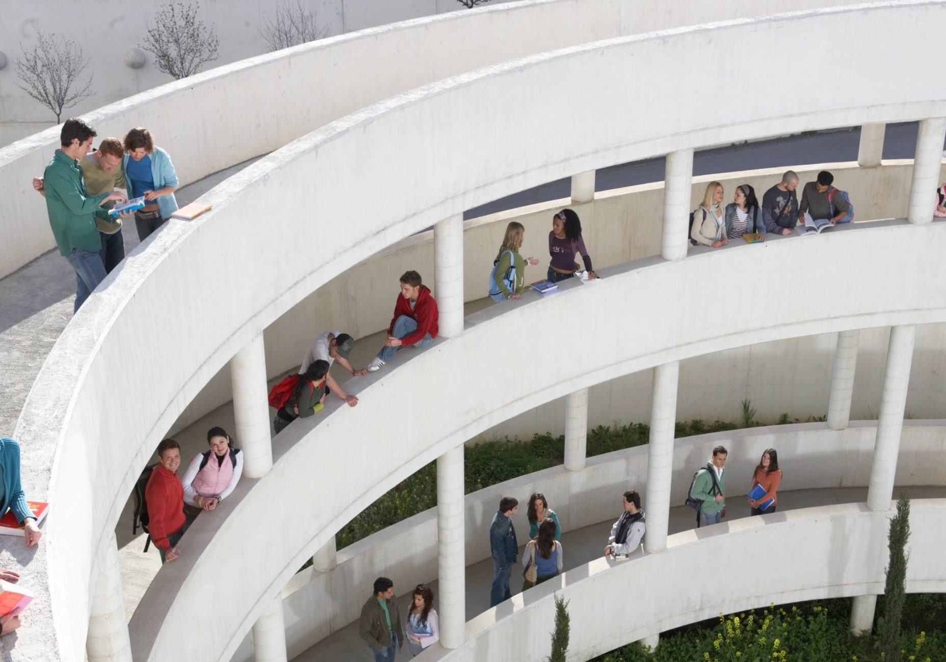Students on curved, multi-level outdoor walkway.