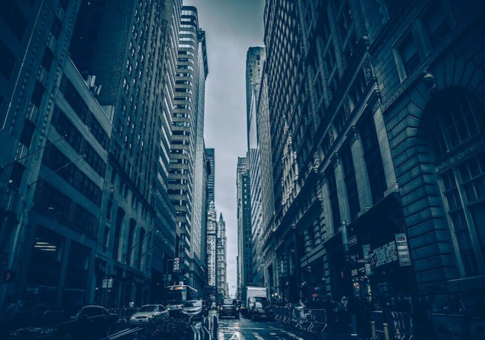 City street with tall buildings, moody atmosphere.