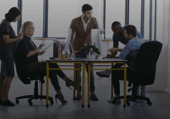 Office team collaborating around a table.