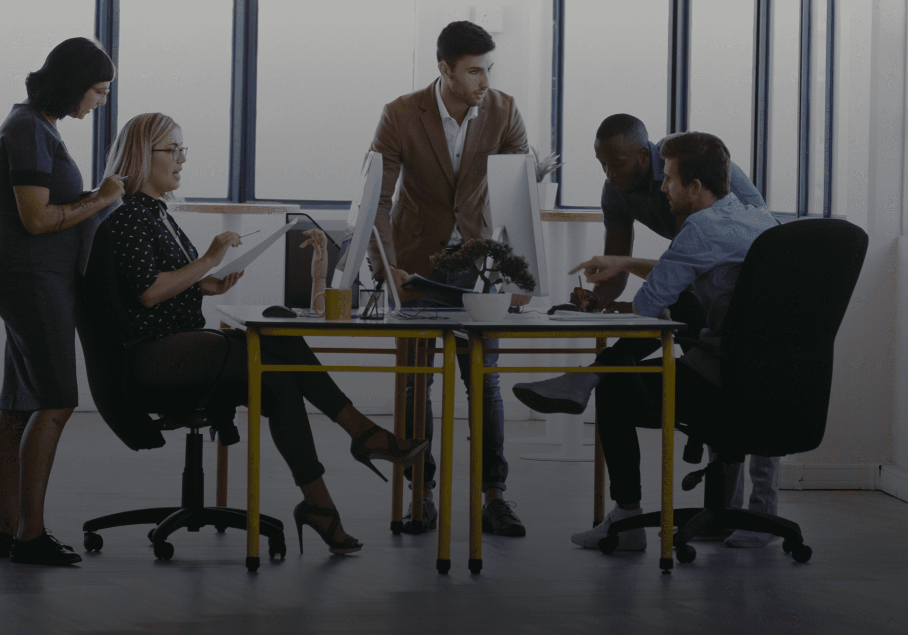 Office team collaborating around a table.