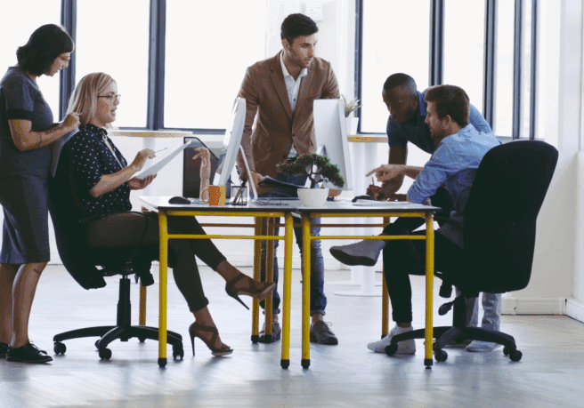 Office team collaborating around a table.