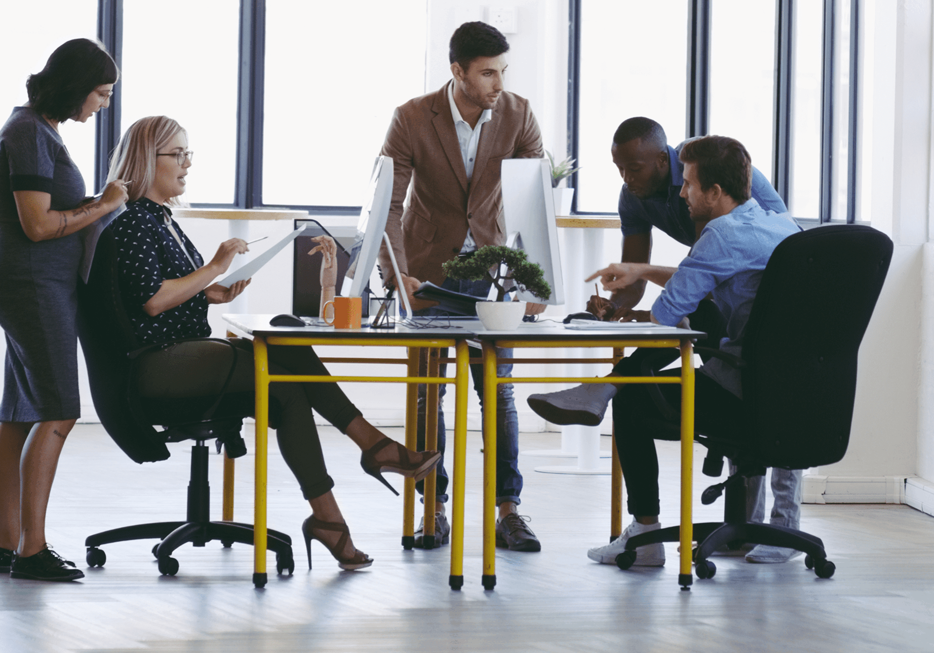 Office team collaborating around a table.