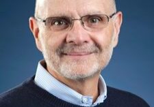 Smiling man with glasses and beard.