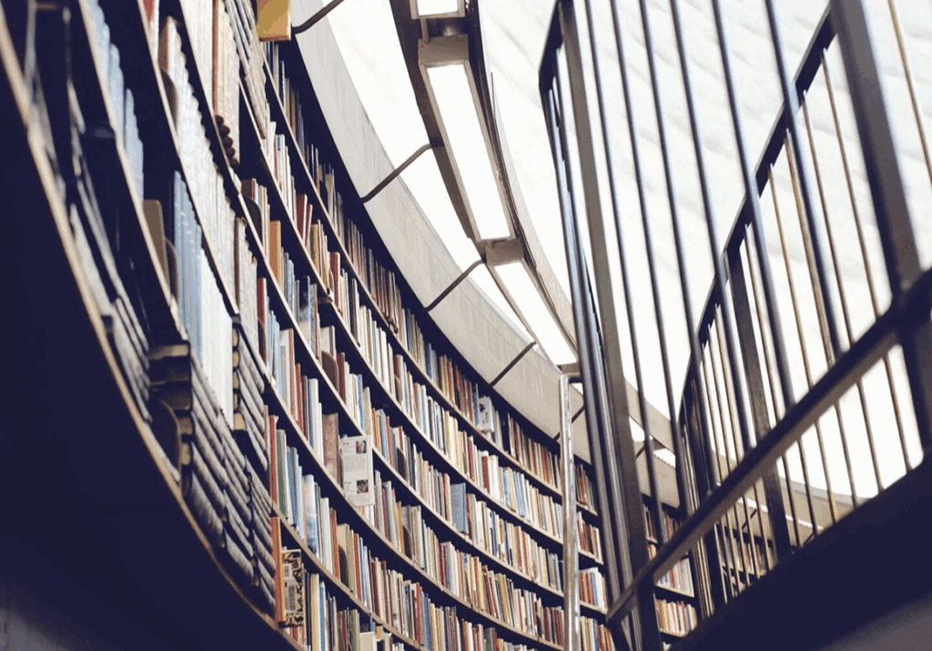 Curved library shelves filled with books.