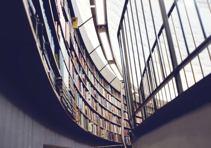 Curved library wall with bookshelves.